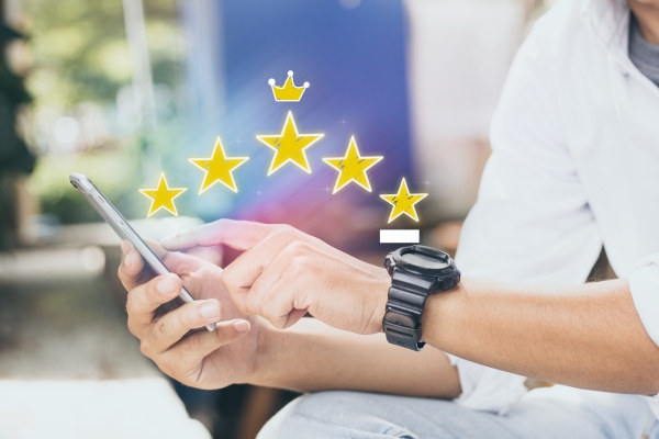 person giving 5 star review on mobile device