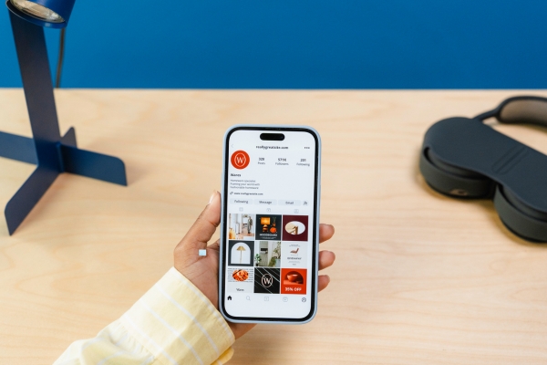 woman holding phone looking at instagram