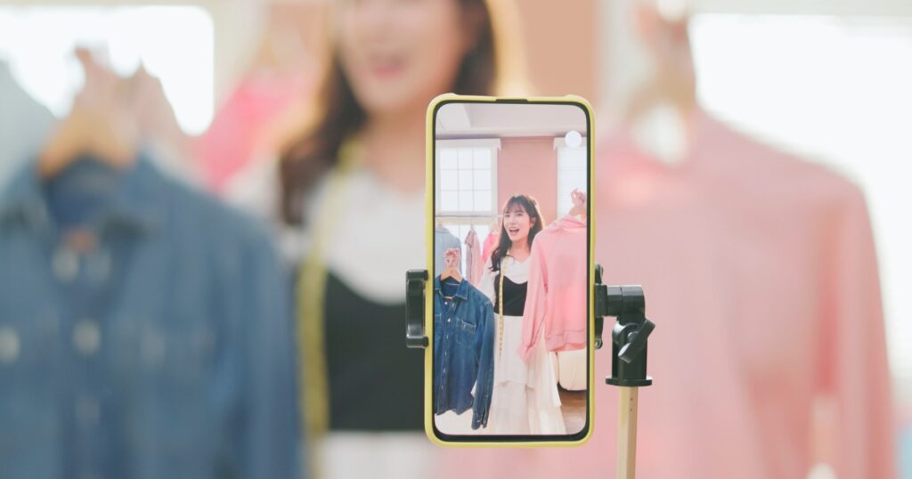 woman recording fashion blog content on her phone