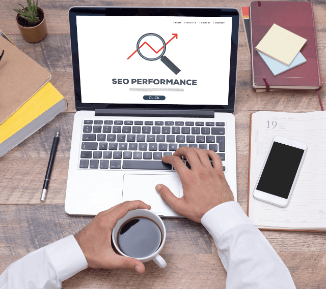 man looking at a computer screen with SEO performance on it