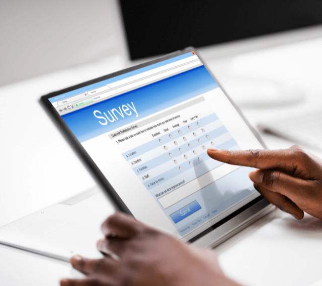 woman filling out a survey on her tablet screen